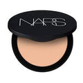 Open black Nars compact showing light peach pressed powder inside.
